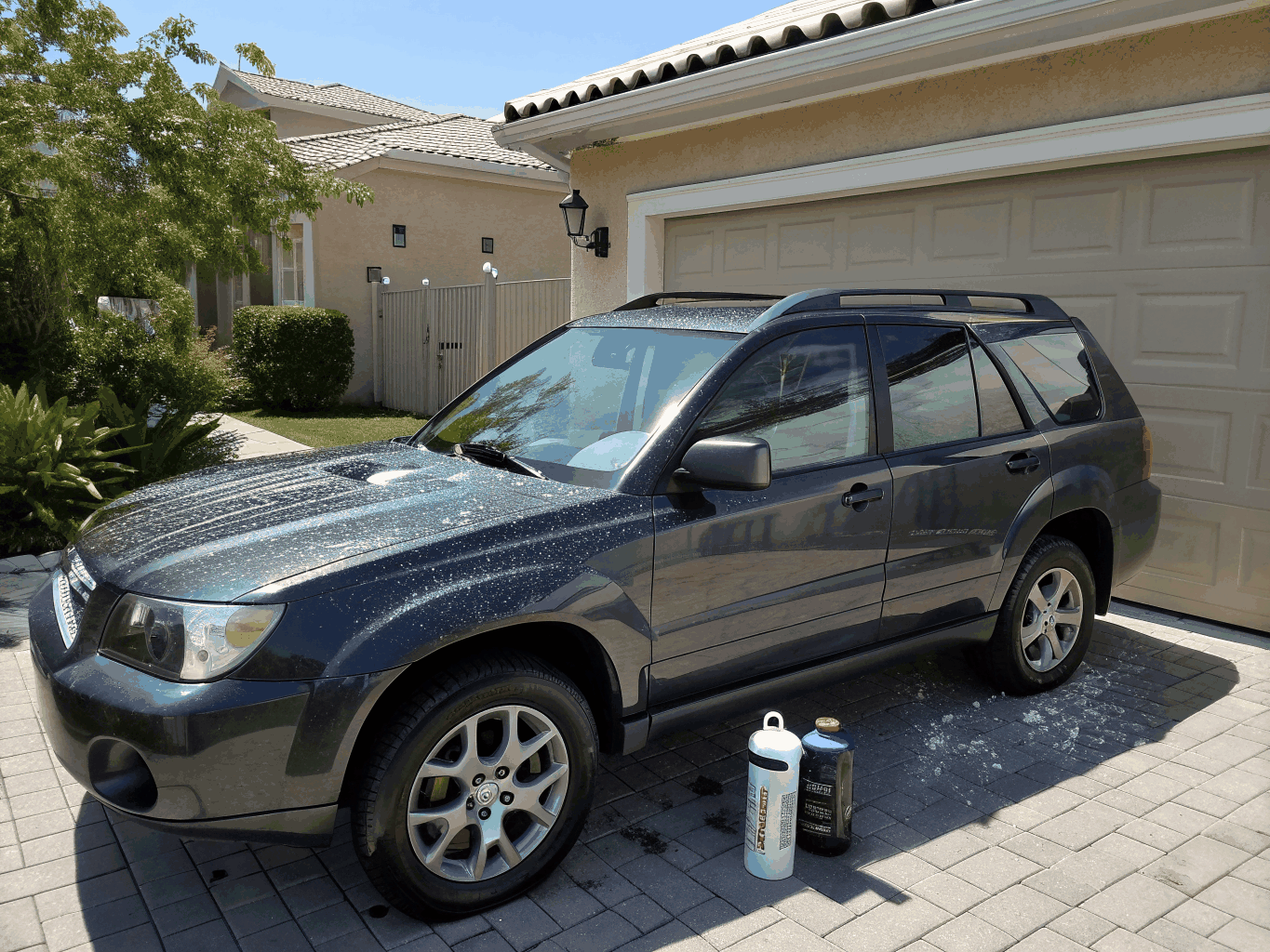 Forest green SUV with hydrophobic water beading on hood